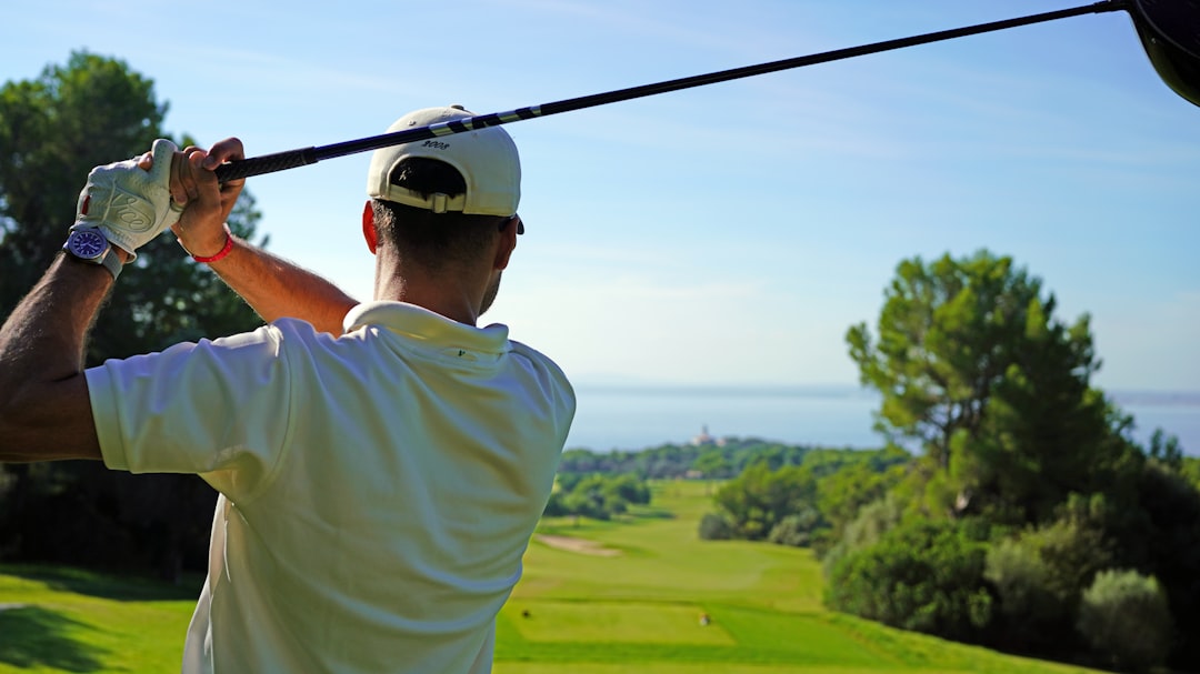 A man swinging a golf club on a golf course