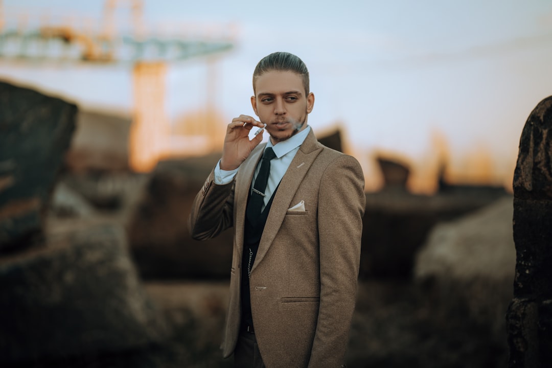 A man in a suit talking on a cell phone