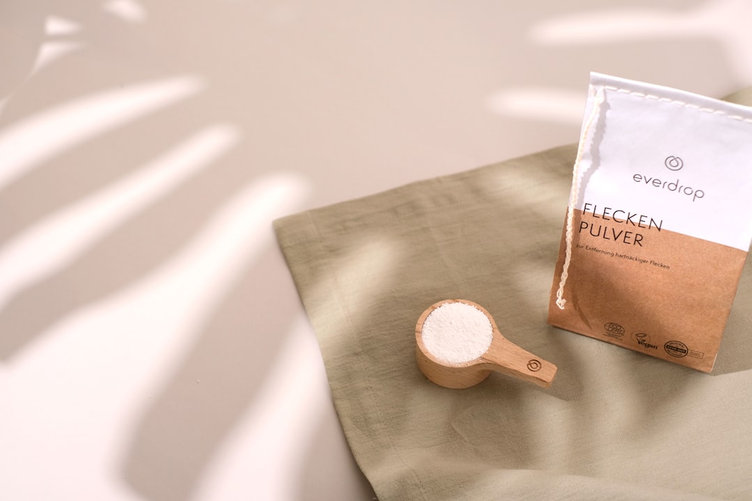a bag of coffee next to a wooden spoon