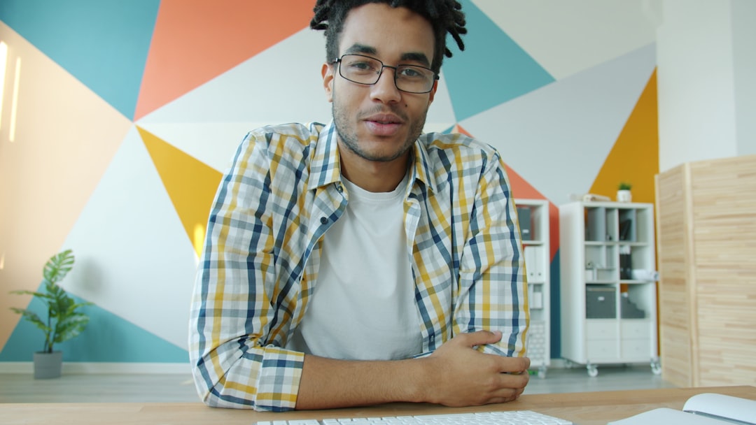 Man with dreadlocks talking on video call