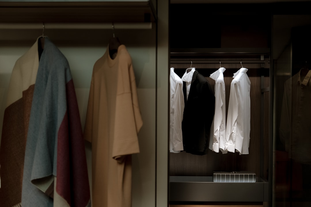 a closet with clothes hanging on a rail