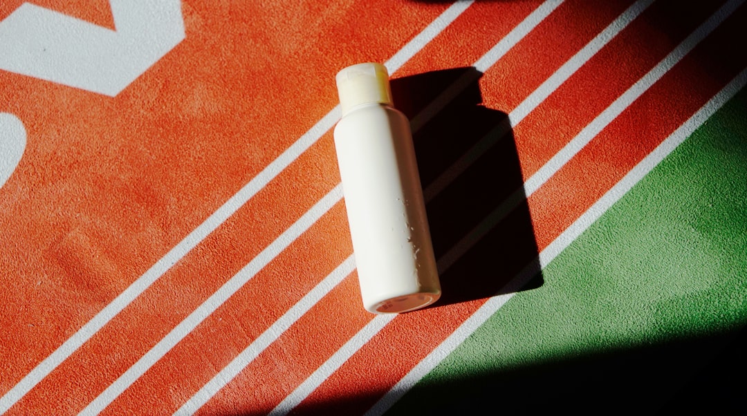 a bottle of lotion sitting on top of a towel