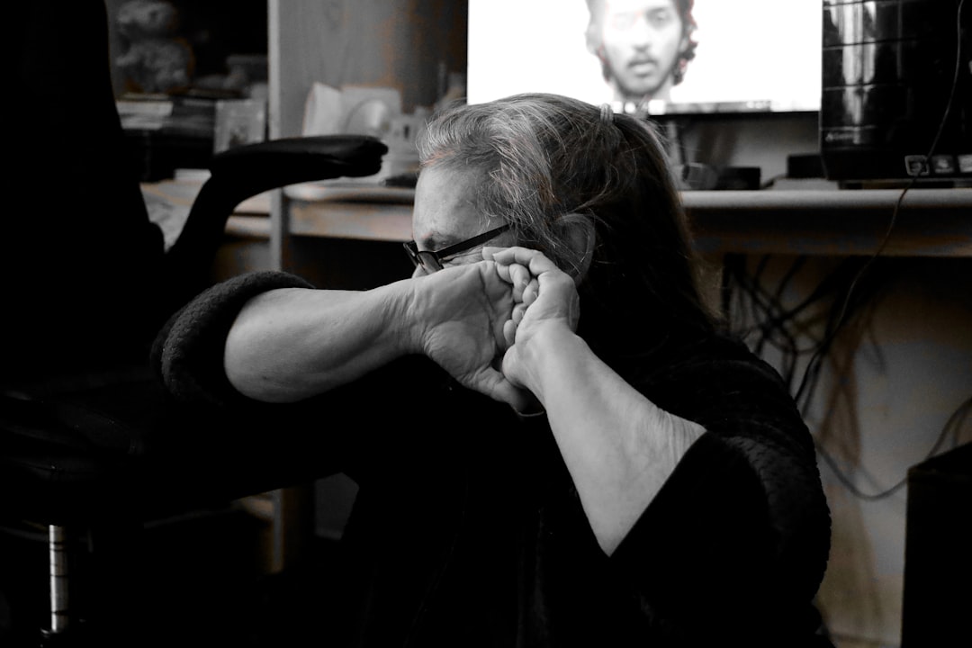 A person holding their hands to their face.