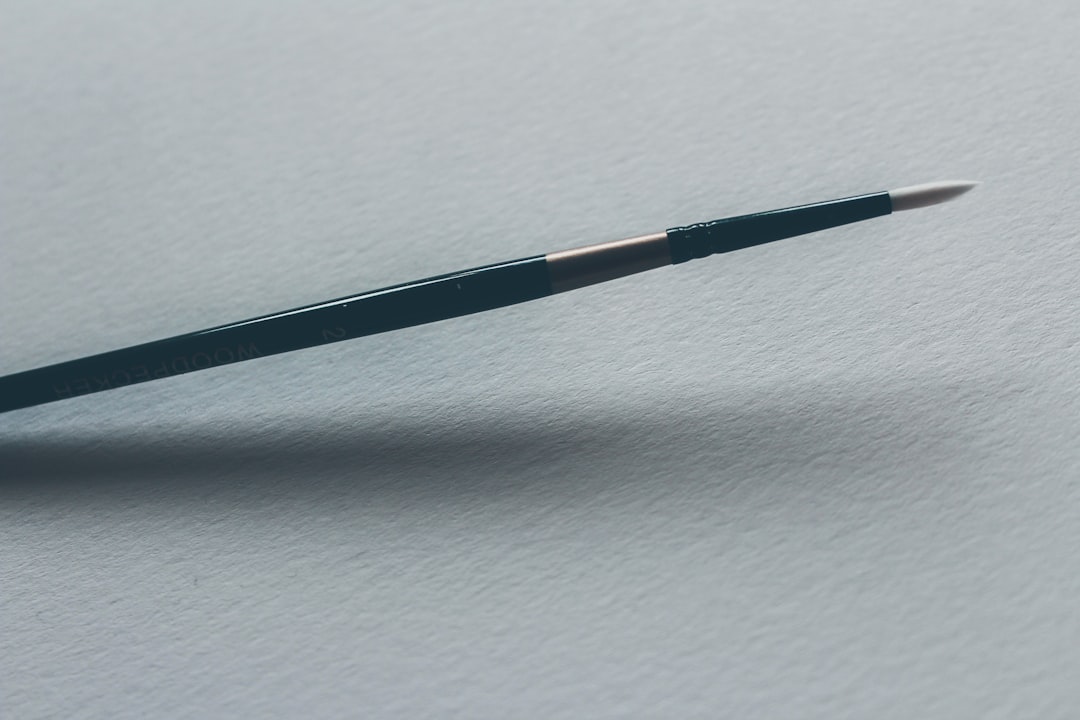 close-up photo of green and gray pen