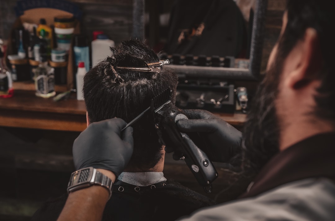 A man getting his hair cut in a barber shop