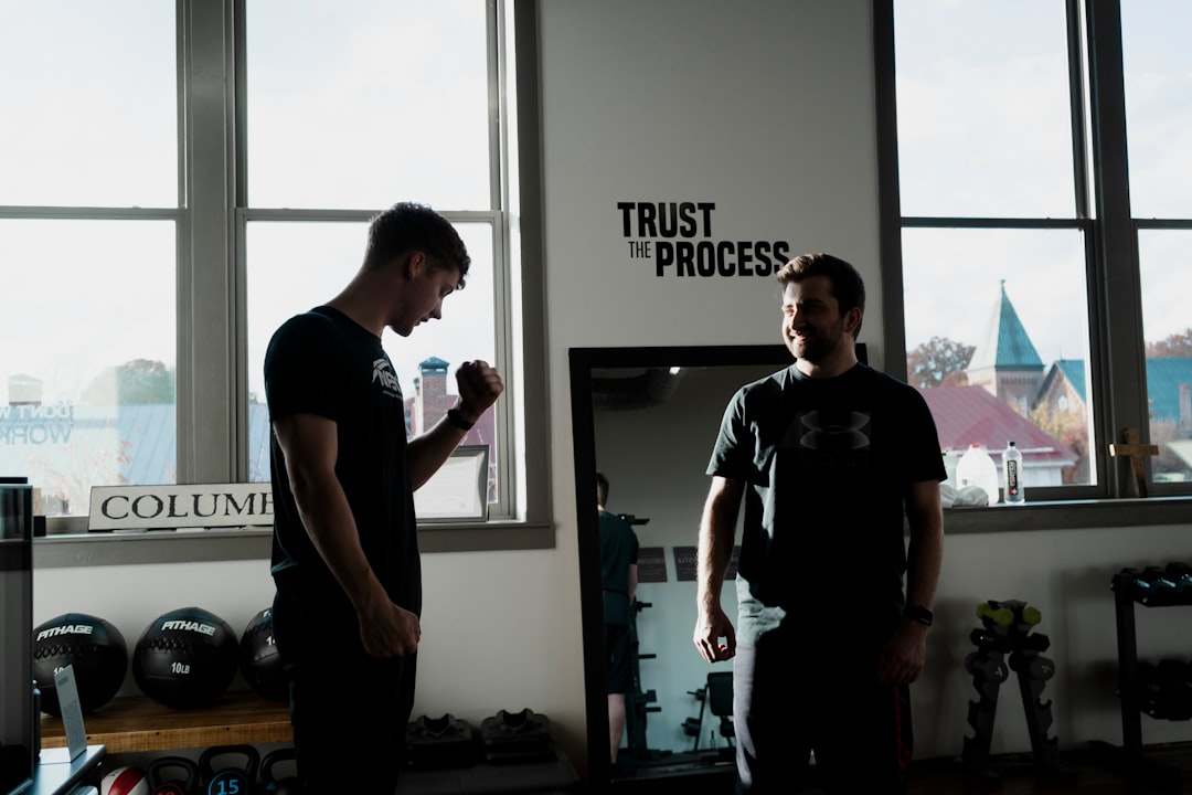 a couple of men standing in front of a window