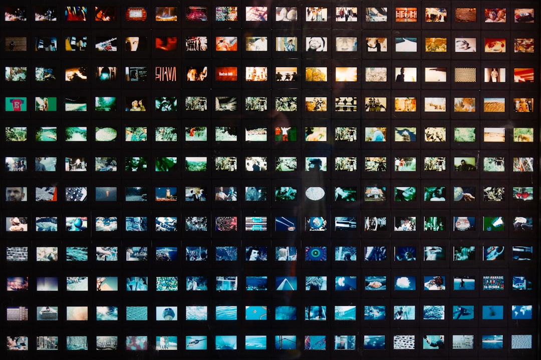 a black wall with a lot of different pictures on it