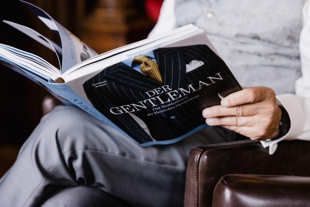 a man sitting in a chair reading a book