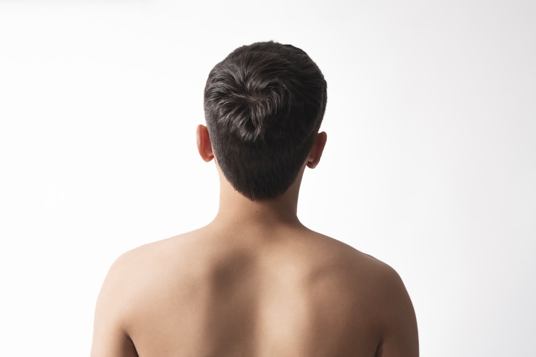 Back view of a young man's shoulders and head